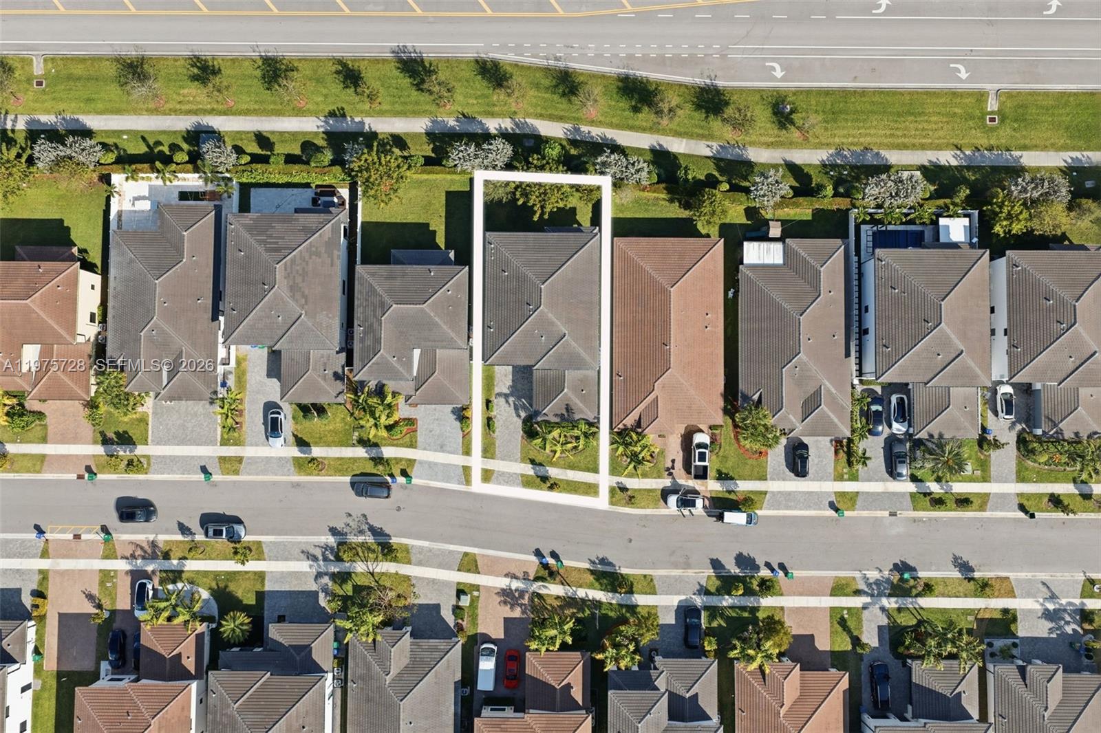 This aerial view shows a residential neighborhood with houses, driveways, and a nearby road — 4409 SW 173rd Ave, Miramar FL 33029, MIRAMAR, FL