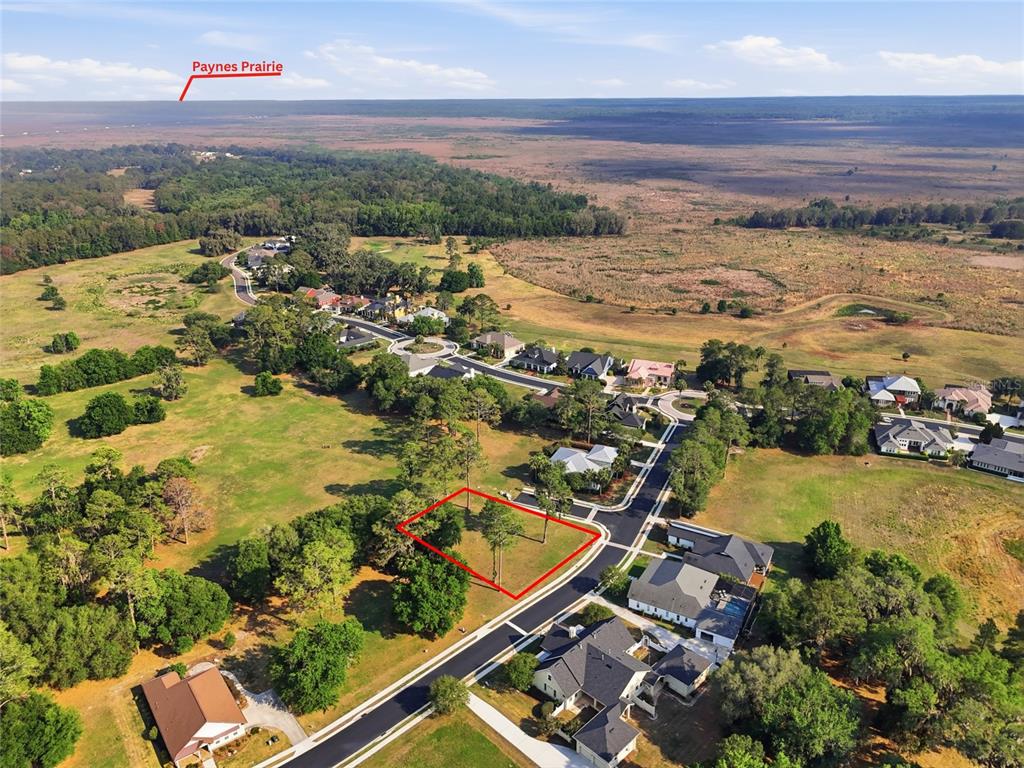 An aerial view shows a vacant residential lot outlined in red within a suburban neighborhood — 6723 SW 40TH TERRACE, GAINESVILLE, FL