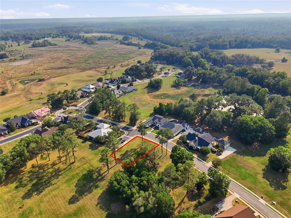 An aerial view shows a vacant rectangular lot outlined in red within a residential neighborhood — 6723 SW 40TH TERRACE, GAINESVILLE, FL