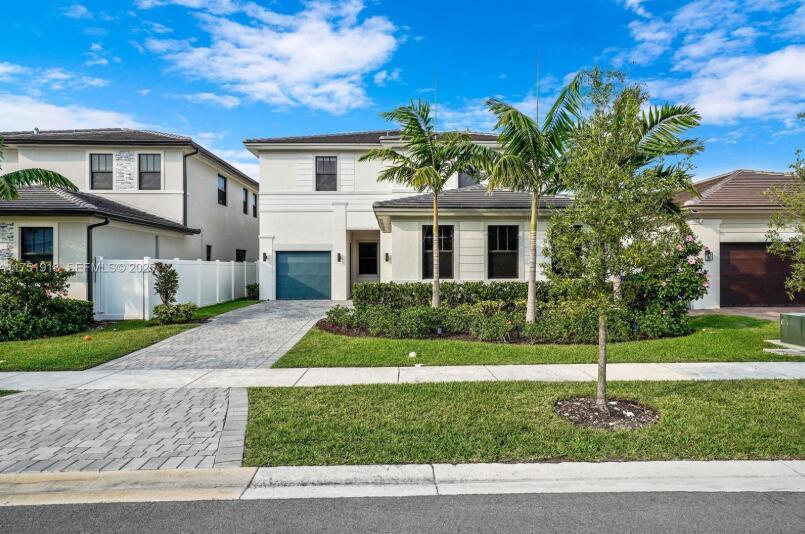 A two-story house with a paved driveway, palm trees, and a white fence — 17325 SW 41 Street, Miramar FL 33029, MIRAMAR, FL