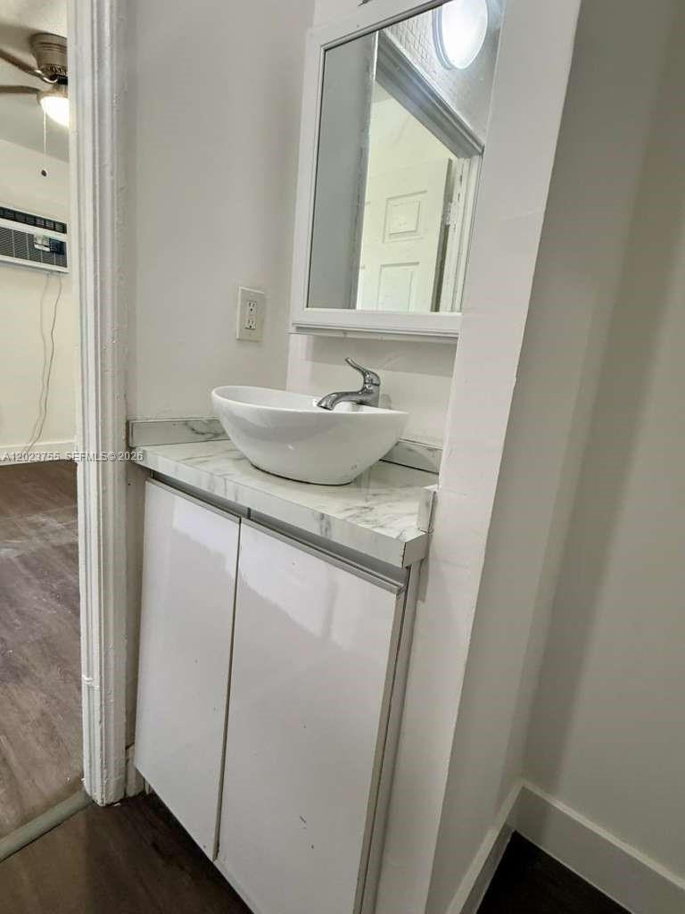 A bathroom vanity features a white vessel sink, marble-patterned countertop, and a wall-mounted mirror — 6026 SW 27th St # 1, Miramar FL 33023, MIRAMAR, FL