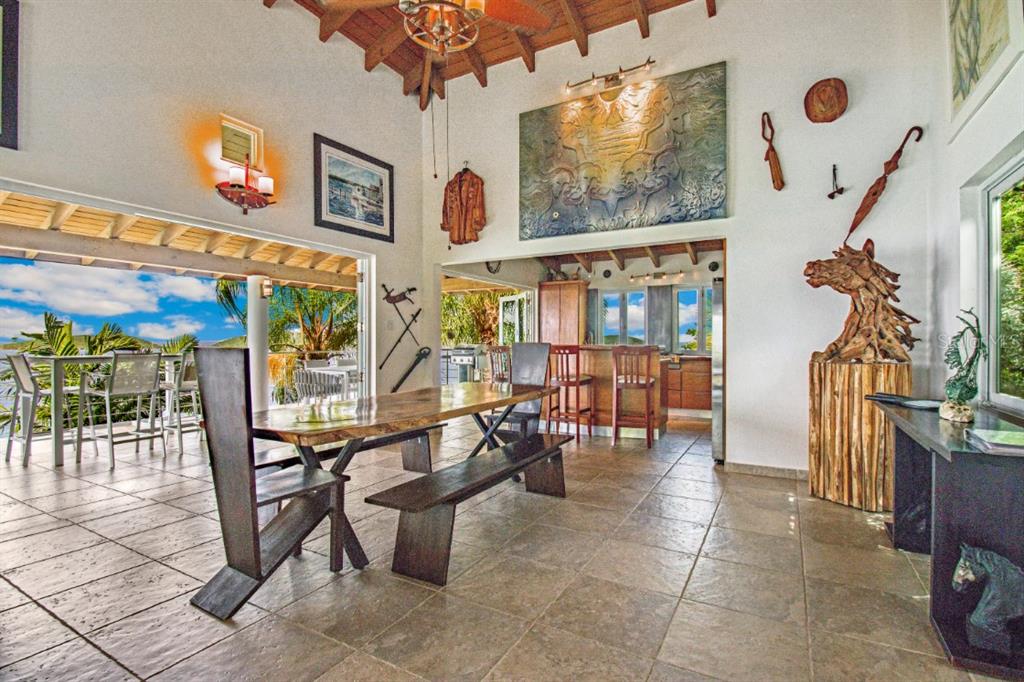 A dining area with a wooden table, tile floors, and an open view to a patio — BO FLAMENCO LAS QUINTAS SOLAR 15 UNIT Sec La Quintas Solar 15, CULEBRA, PR