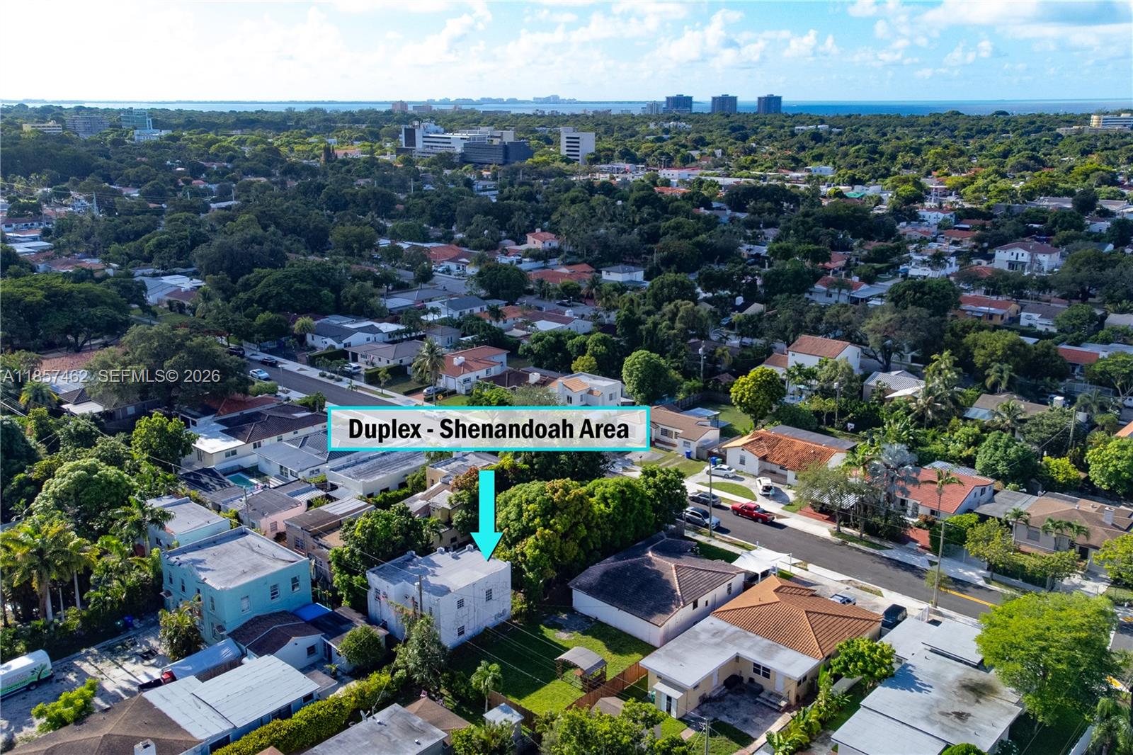 An aerial view shows a white duplex building in a residential neighborhood with lush trees — 2367 SW 19th St, Miami FL 33145, MIAMI, FL