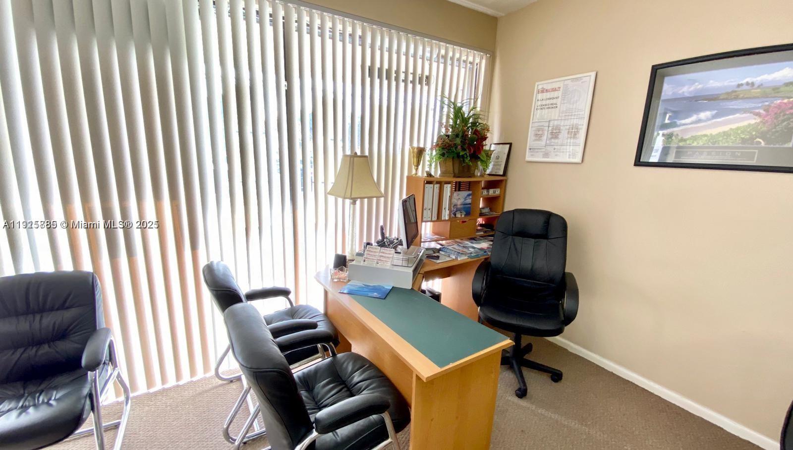 An office features a wooden desk, black chairs, vertical blinds, and wall-mounted decor — 934 S Dixie, Lantana FL 33462, LANTANA, FL