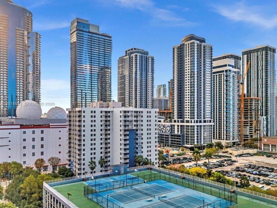 An elevated view of a tennis court with several high-rise apartment buildings in the background — 800 N MIAMI AVE # 1210, Miami FL 33136, MIAMI, FL