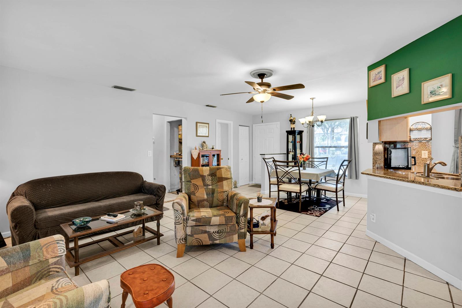 A living room and dining area with tile floors, a ceiling fan, and green accents — 3 Vía De Casas Sur # 102, Boynton Beach FL 33426, BOYNTON BEACH, FL