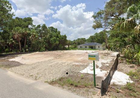 A vacant residential lot with a cleared building pad and a nearby house in view — ANANAS ROAD, NORTH PORT, FL