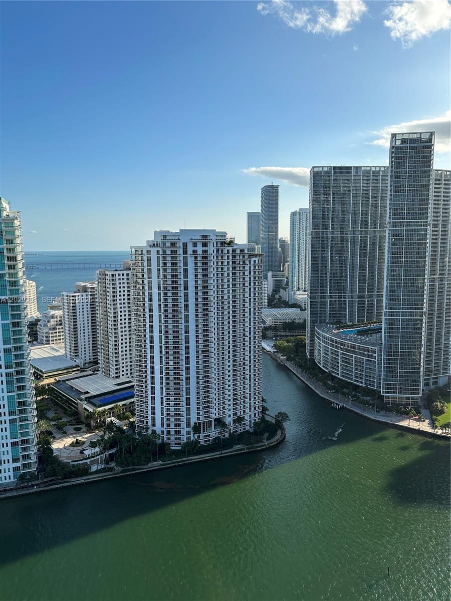 An aerial view of high-rise apartment buildings situated along a canal in a coastal city — 325 S Biscayne Blvd # 4119, Miami FL 33131, MIAMI, FL