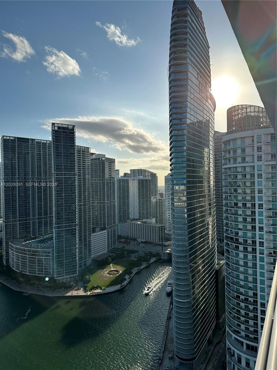 An elevated view of a city skyline featuring modern skyscrapers, a river, and boats — 325 S Biscayne Blvd # 4119, Miami FL 33131, MIAMI, FL