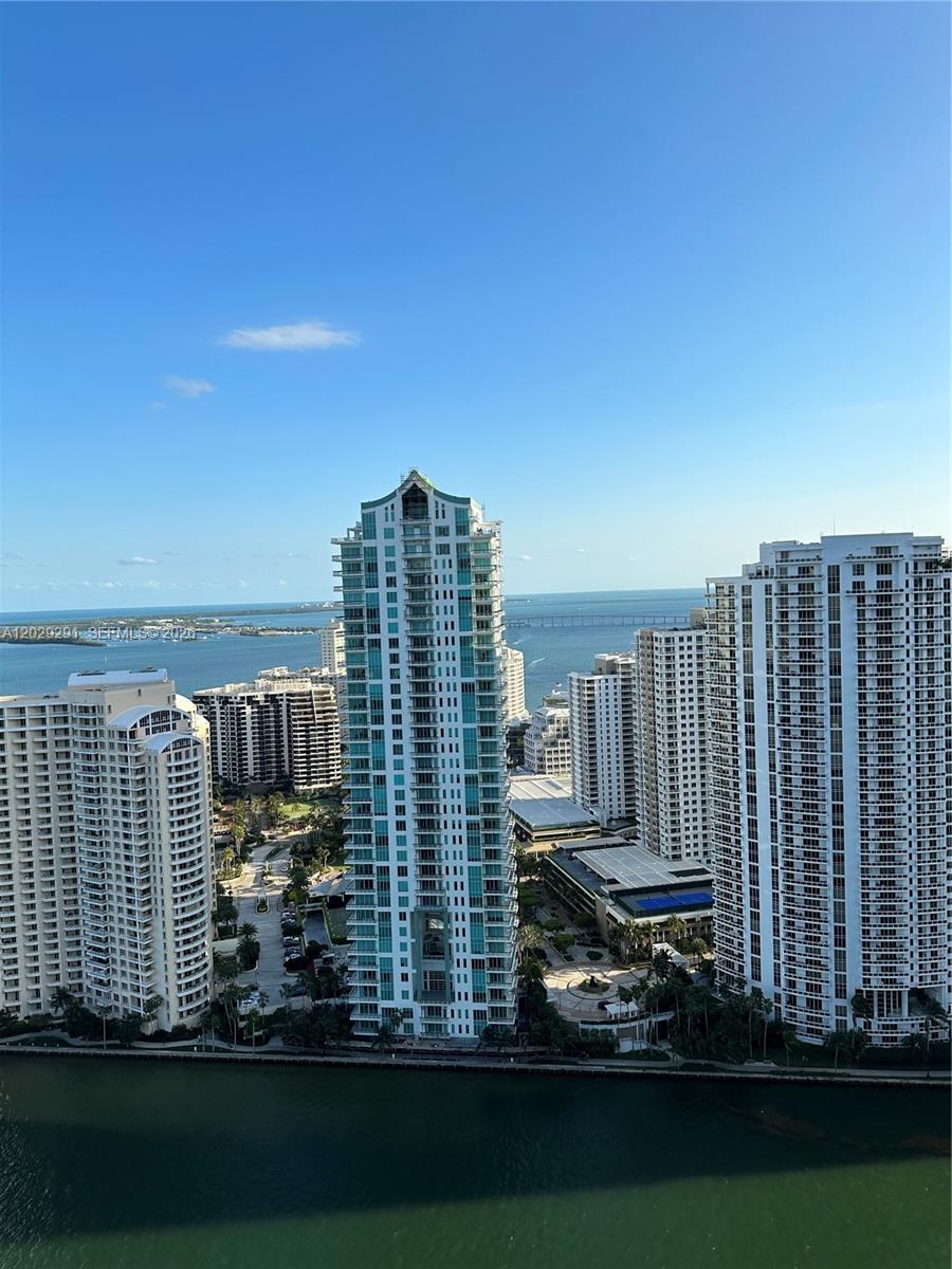 An aerial view shows several high-rise residential buildings situated along a waterfront — 325 S Biscayne Blvd # 4119, Miami FL 33131, MIAMI, FL
