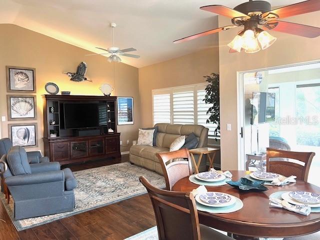 A living room and dining area feature hardwood floors, a ceiling fan, and neutral walls — 1010 ISLAMORADA BOULEVARD, PUNTA GORDA, FL