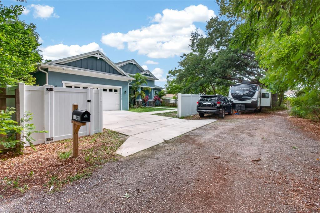 A blue house with a white garage, a driveway, and a parked RV and SUV — 11560 110TH AVENUE, LARGO, FL
