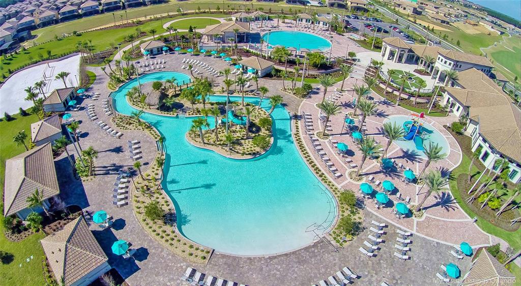 An aerial view of a resort-style swimming pool complex with a lazy river and slides — 1159 DROP LANE, DAVENPORT, FL