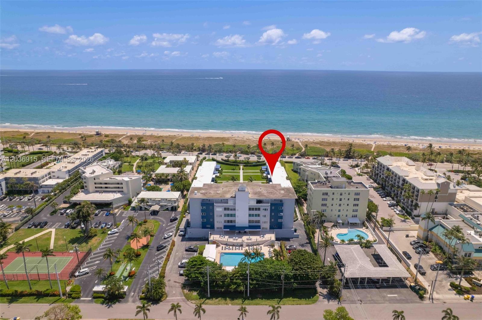 An aerial view shows a multi-story apartment building with a pool near the ocean — 120 N Ocean Blvd # 6, Delray Beach FL 33483, DELRAY BEACH, FL