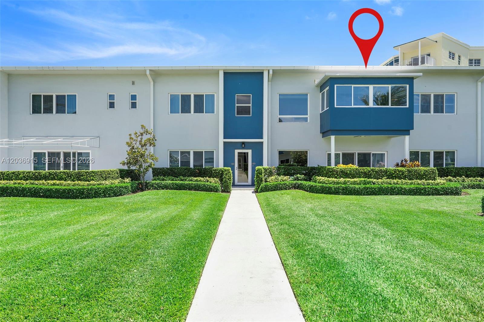 The exterior of a two-story apartment building features a blue-accented facade and manicured lawn — 120 N Ocean Blvd # 6, Delray Beach FL 33483, DELRAY BEACH, FL