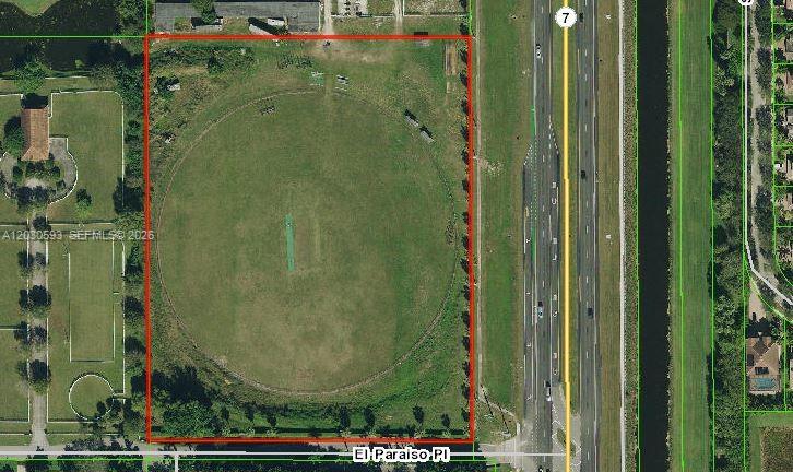 An aerial view shows a rectangular plot of land containing a circular cricket field — n/a El Paraiso Pl, Delray Beach FL 33446, DELRAY BEACH, FL