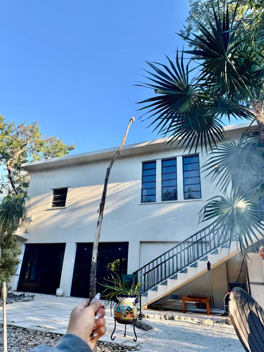 A hot tub sits under a wooden pergola on a paved patio in a backyard — 1615 Harbor Dr, Marathon FL 33050, MARATHON, FL