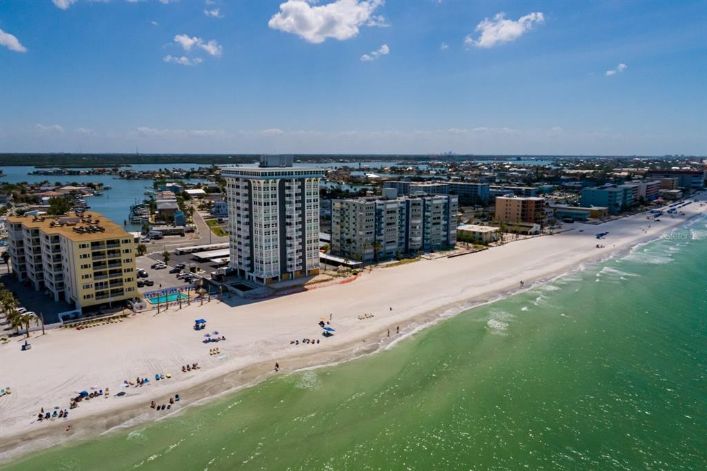 An aerial view of a sandy beach with high-rise condominiums along the coastline — 17408 GULF BOULEVARD UNIT 203, REDINGTON SHORES, FL