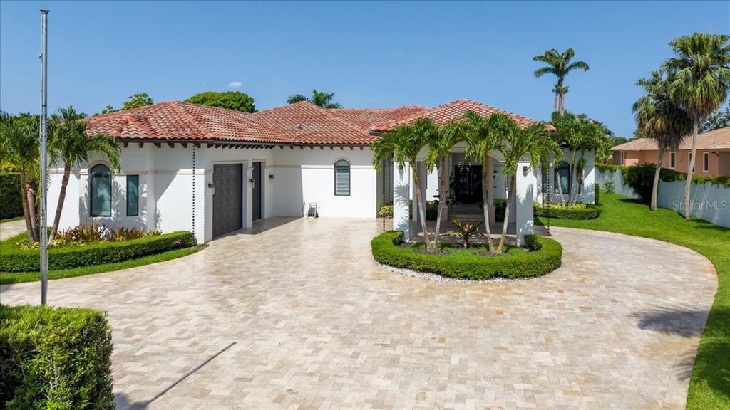 A single-story house with a tiled roof, white stucco exterior, and a circular paver driveway — 331 SW 124TH AVENUE, MIAMI, FL