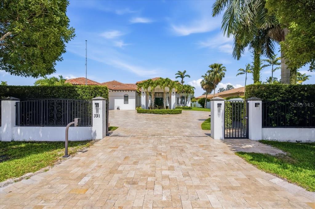 A paved driveway leads to the entrance of a white house with a tile roof — 331 SW 124TH AVENUE, MIAMI, FL