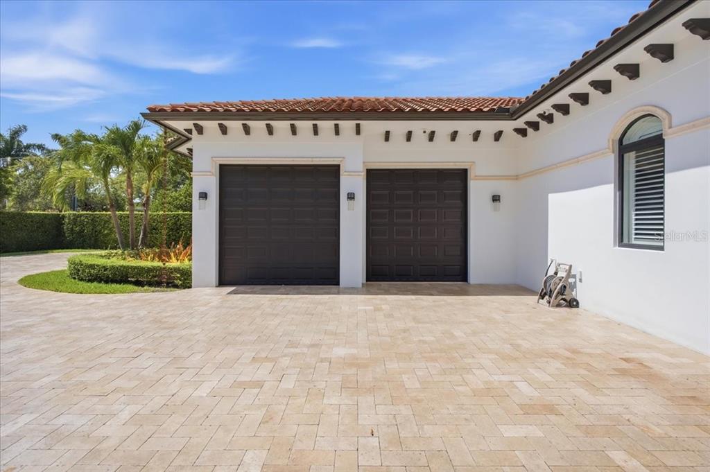 A two-car garage with dark doors and a paved driveway in front of a house — 331 SW 124TH AVENUE, MIAMI, FL