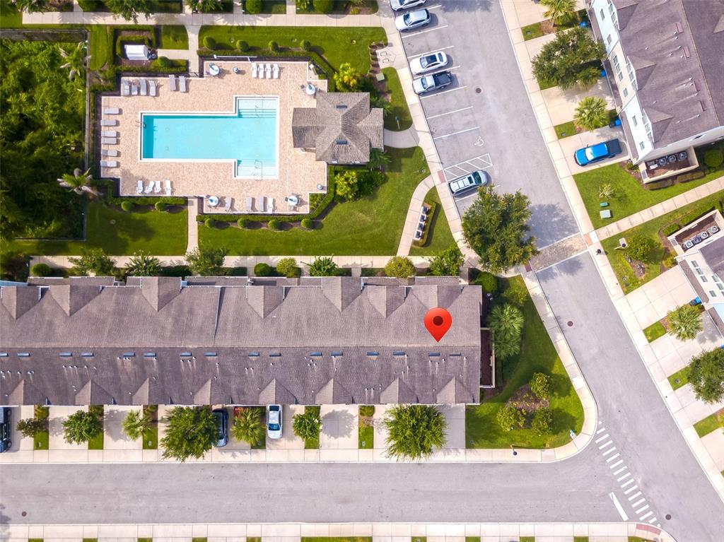 An aerial view shows a townhome complex with a swimming pool and parking lot — 459 PORTICO COURT, OVIEDO, FL