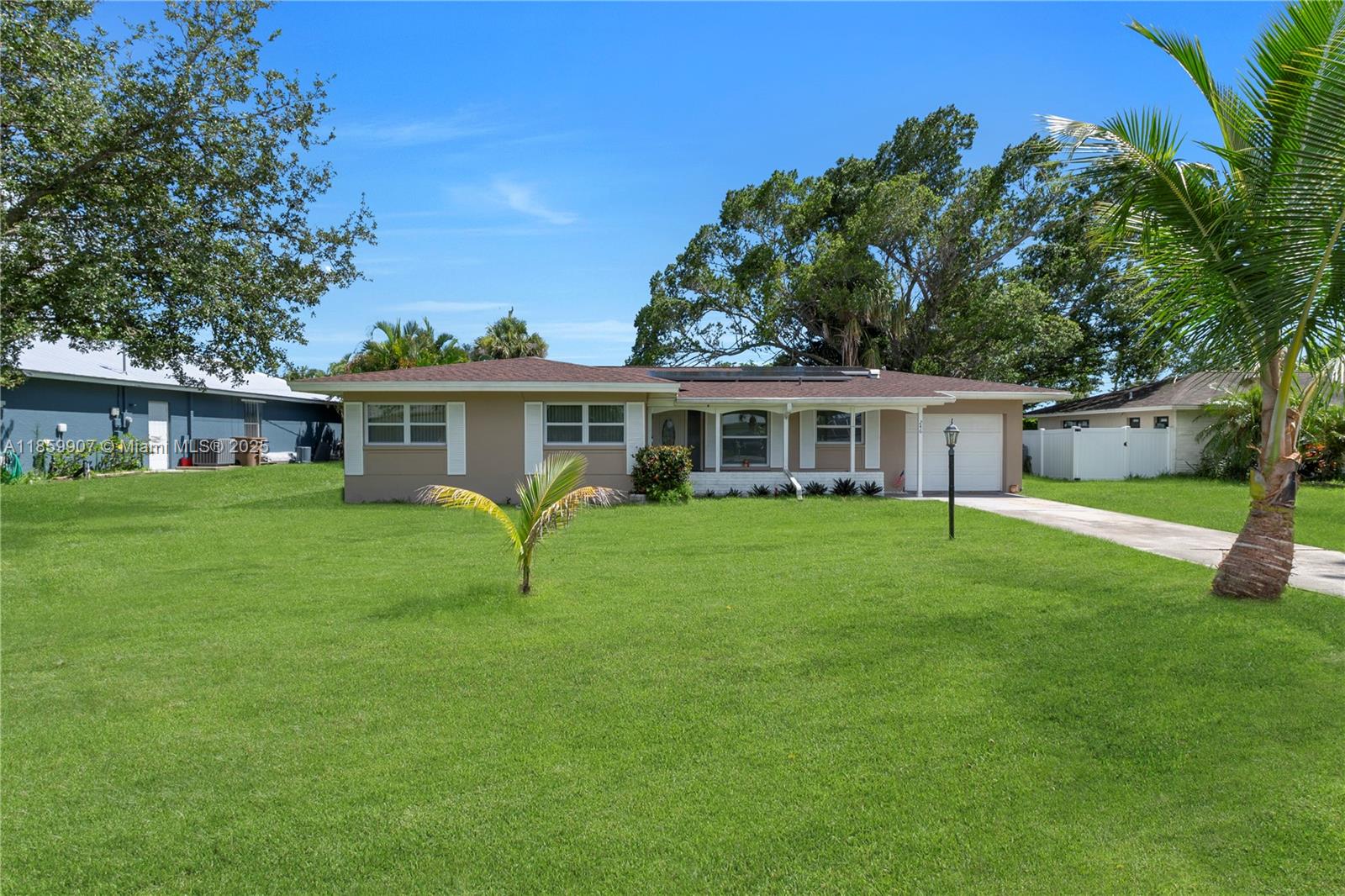 A single-story house with a tan exterior, a brown roof, and a large front lawn — 246 SE 44th st, Cape Coral FL 33904, CAPE CORAL, FL