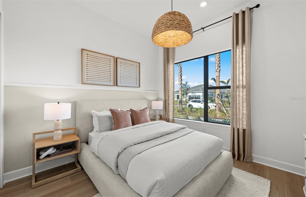 A bedroom features a platform bed, a woven pendant light, and a window with curtains — 4829 LONG POINT RUN, LAKEWOOD RANCH, FL