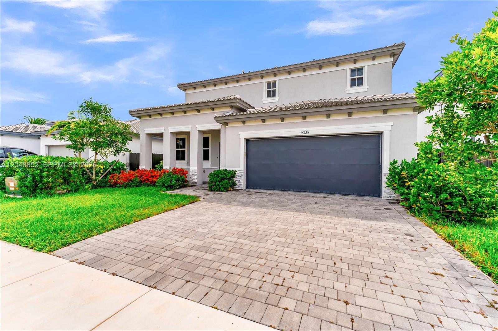 A two-story house with a gray exterior, a two-car garage, and a paved driveway — 16125 SW 149th Ave, Miami FL 33187, MIAMI, FL