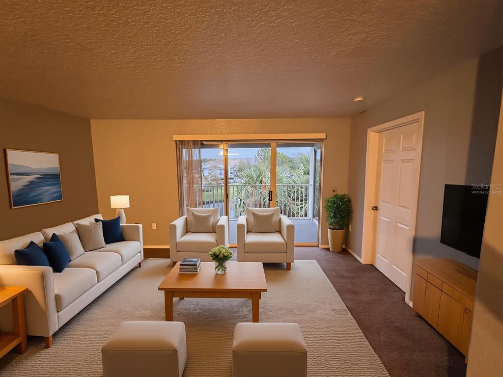 A living room features a sofa, two armchairs, a coffee table, and a sliding glass door — 13838 FAIRWAY ISLAND DRIVE UNIT 1432, ORLANDO, FL