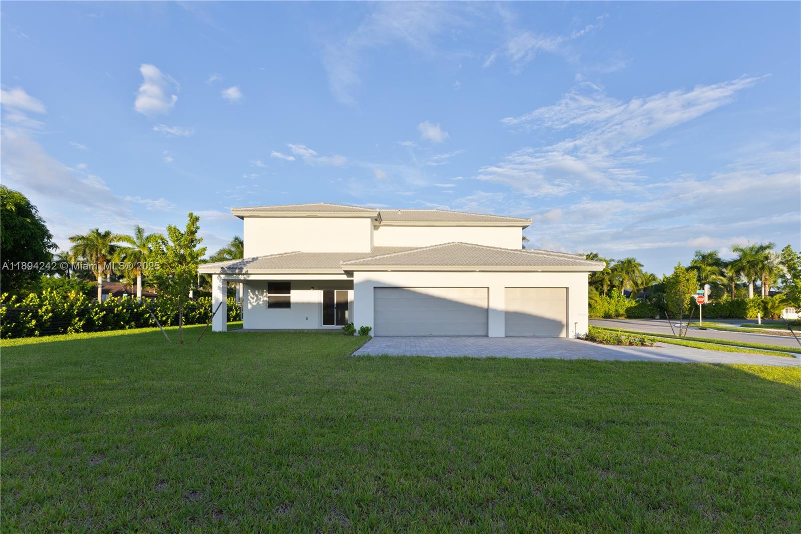 A two-story house with a white exterior, a gray tiled roof, and a two-car garage — 13203 SW 188th Ter, Miami FL 33177, MIAMI, FL