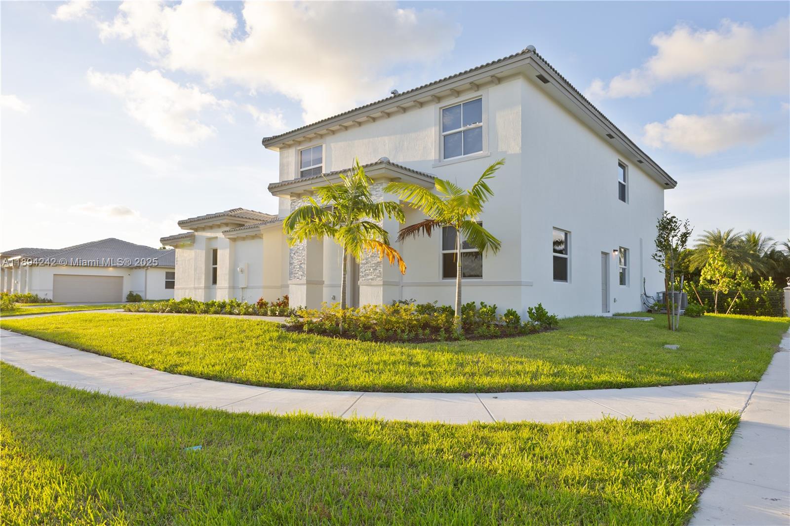 A two-story white stucco house features a stone-accented entrance and two palm trees — 13203 SW 188th Ter, Miami FL 33177, MIAMI, FL