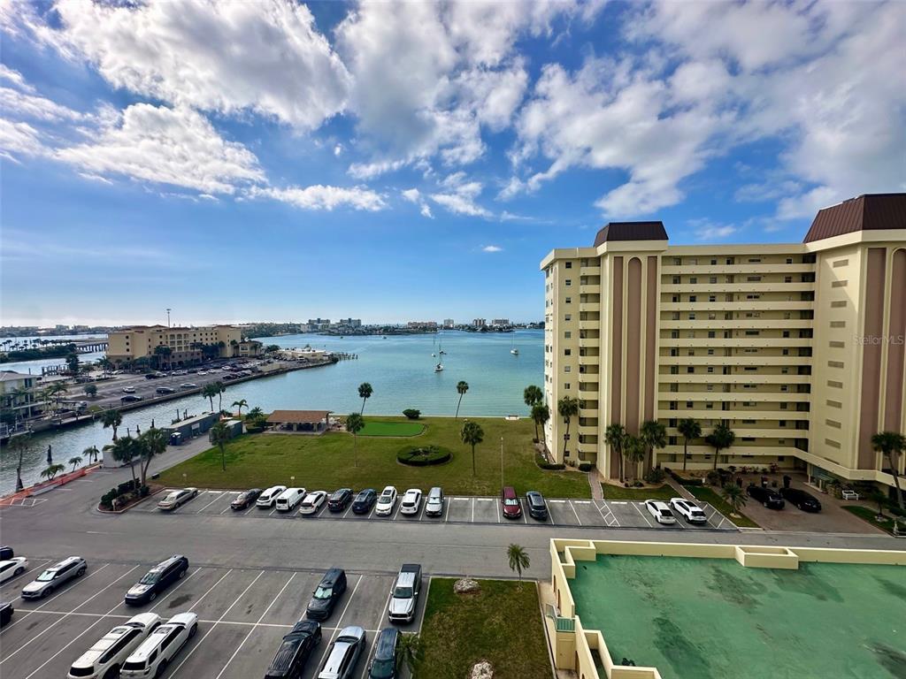 An elevated view shows a parking lot, a grassy area, and a bay with boats — 4550 COVE CIRCLE UNIT 905, ST PETERSBURG, FL