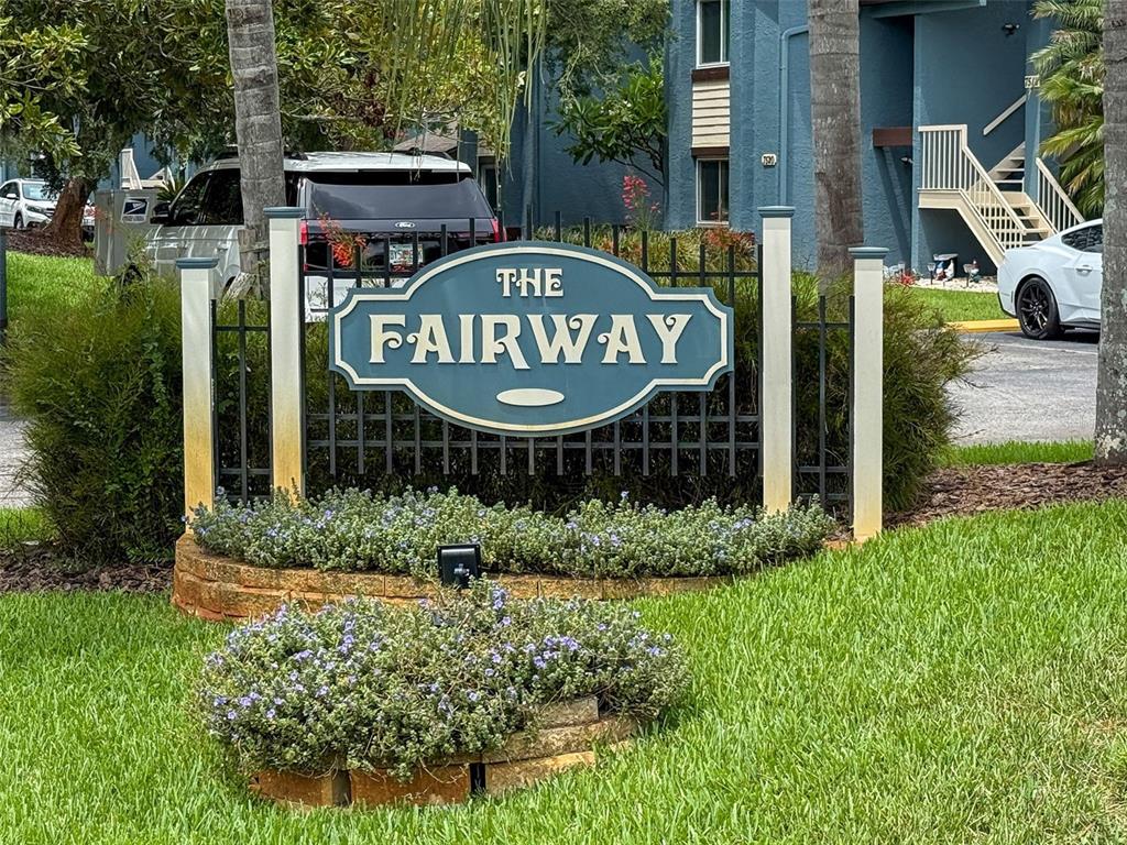A sign for The Fairway apartment complex stands in front of a blue building — 7686 ST ANDREWS BOULEVARD, WEEKI WACHEE, FL