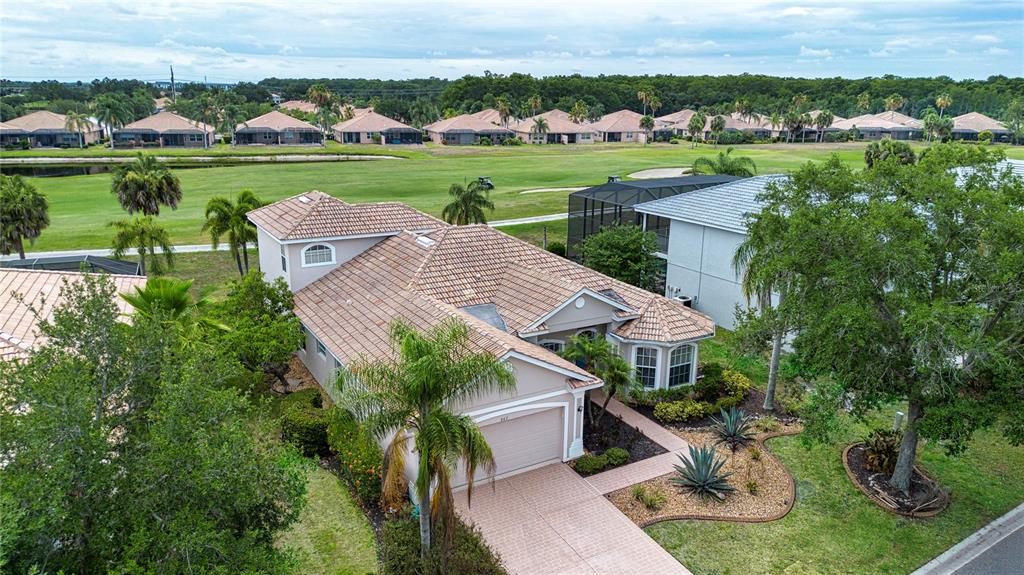 An aerial view of a suburban house with a tiled roof and a golf course — 267 HERITAGE ISLES WAY, BRADENTON, FL
