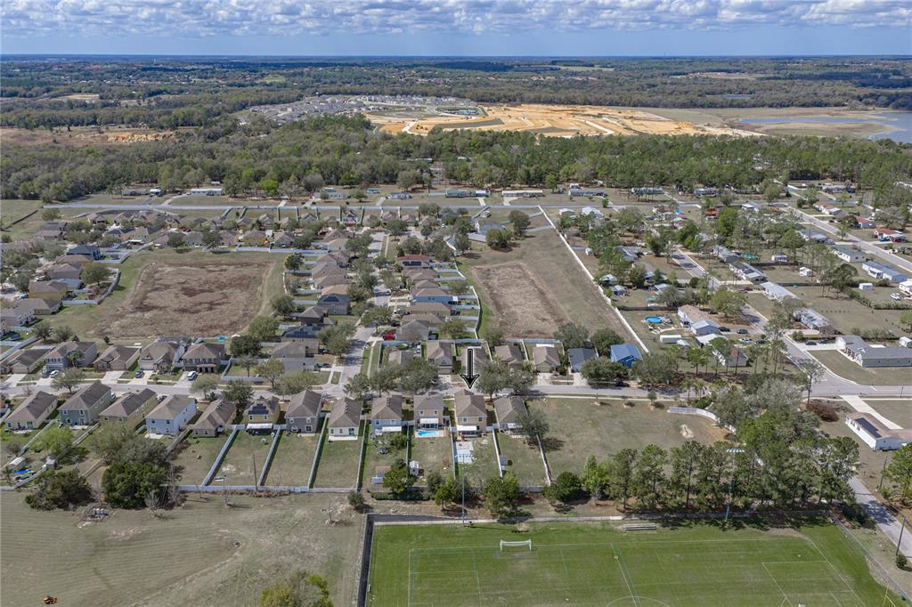 An aerial view shows a residential neighborhood with a house marked by an arrow — 13416 KENT BRADLEY STREET, DADE CITY, FL