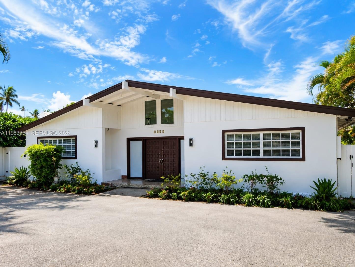 A white single-story house with a brown roof and a large paved driveway — 4560 Prairie Ave, Miami Beach FL 33140, MIAMI BEACH, FL