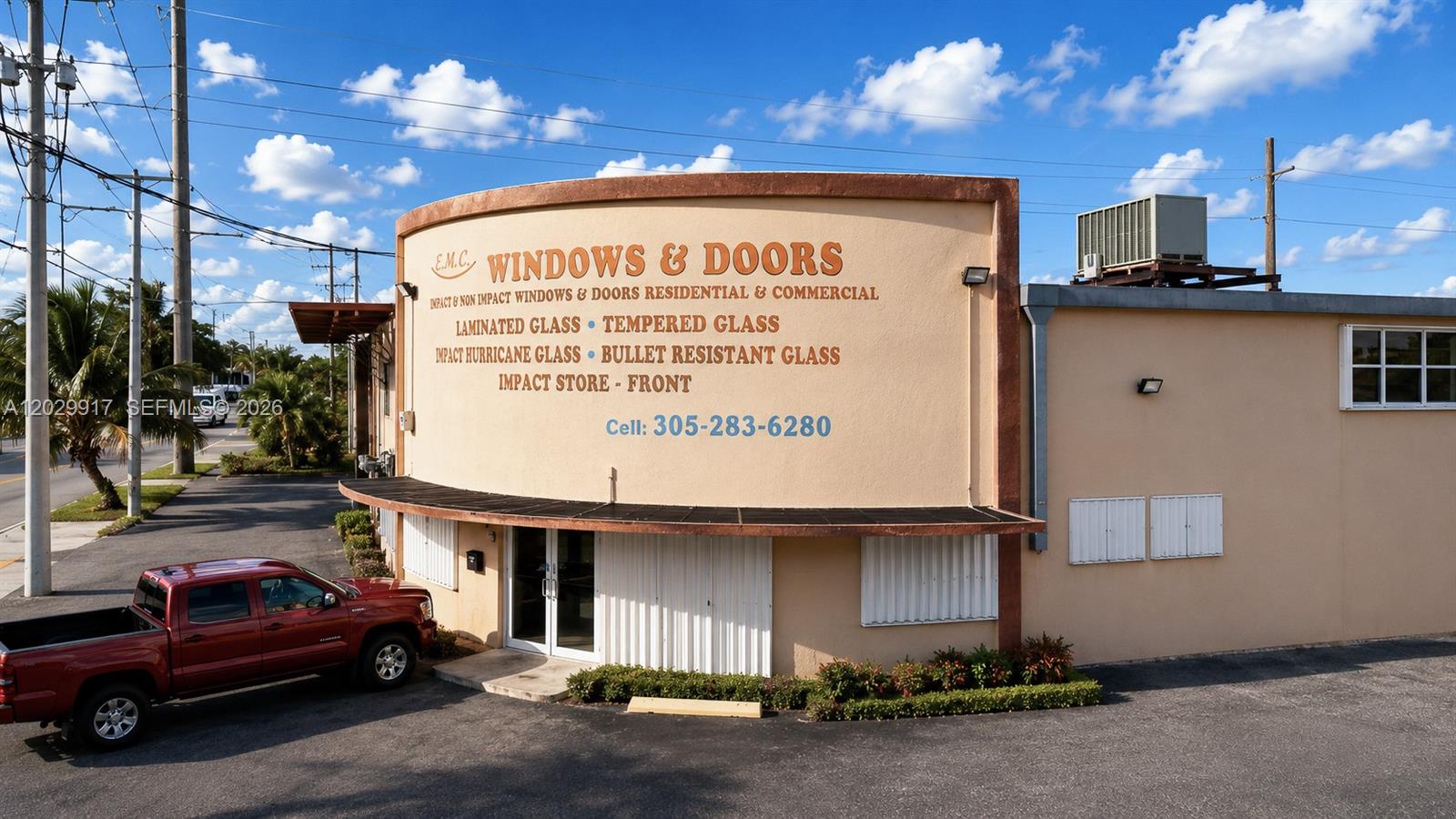 An exterior view of a commercial building with a curved facade and signage for windows — 455 E 10th Ave, Hialeah FL 33010, HIALEAH, FL