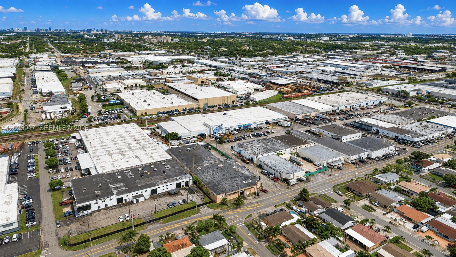 An aerial view shows industrial warehouse buildings surrounded by parking lots and residential streets — 455 E 10th Ave, Hialeah FL 33010, HIALEAH, FL