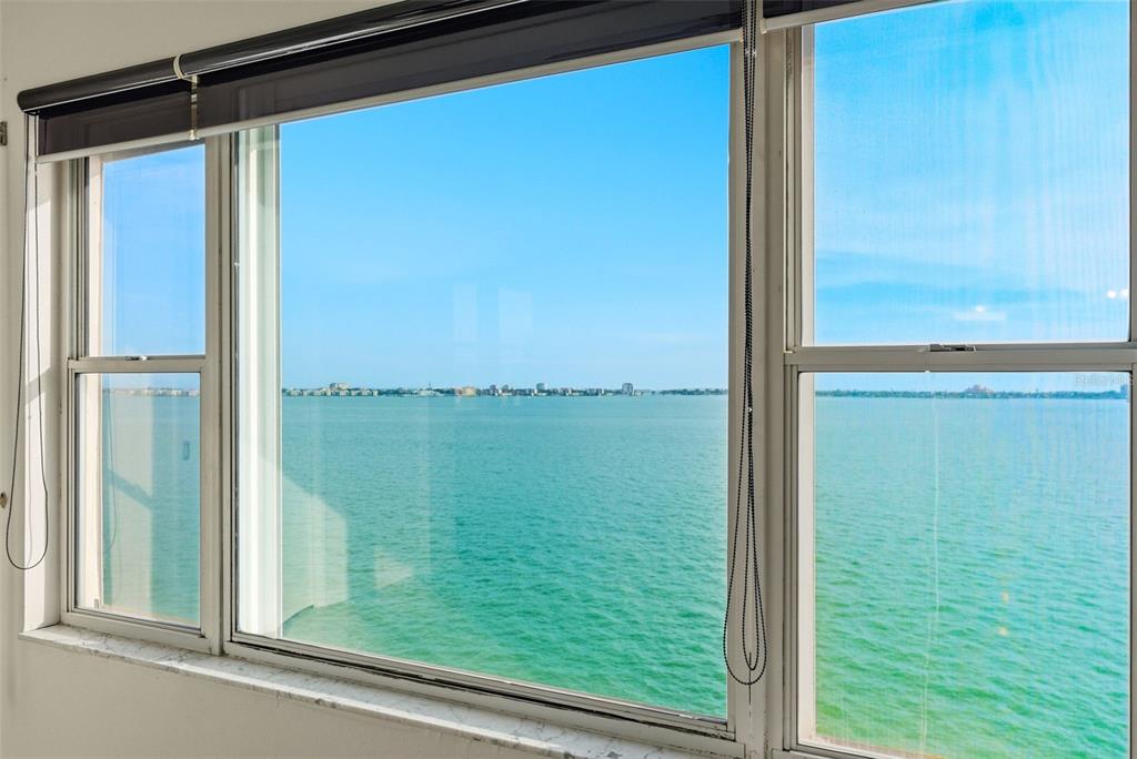 A view of the ocean and distant shoreline through a large multi-pane window — 5980 SHORE BOULEVARD S UNIT 901, GULFPORT, FL