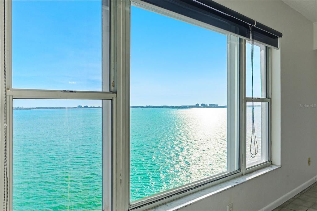 A room with large windows overlooking a bright blue body of water — 5980 SHORE BOULEVARD S UNIT 901, GULFPORT, FL