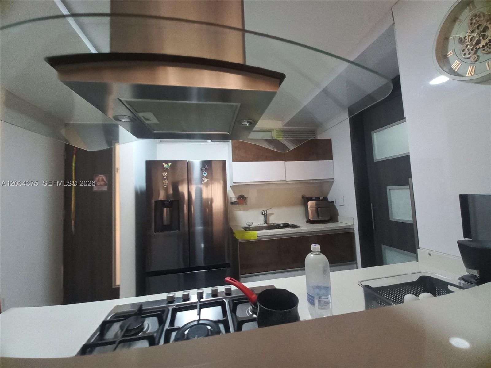 A kitchen features stainless steel appliances, dark wood cabinetry, and a gas stovetop — Cra. 19 # 9 - 110 # 101, FL, FL