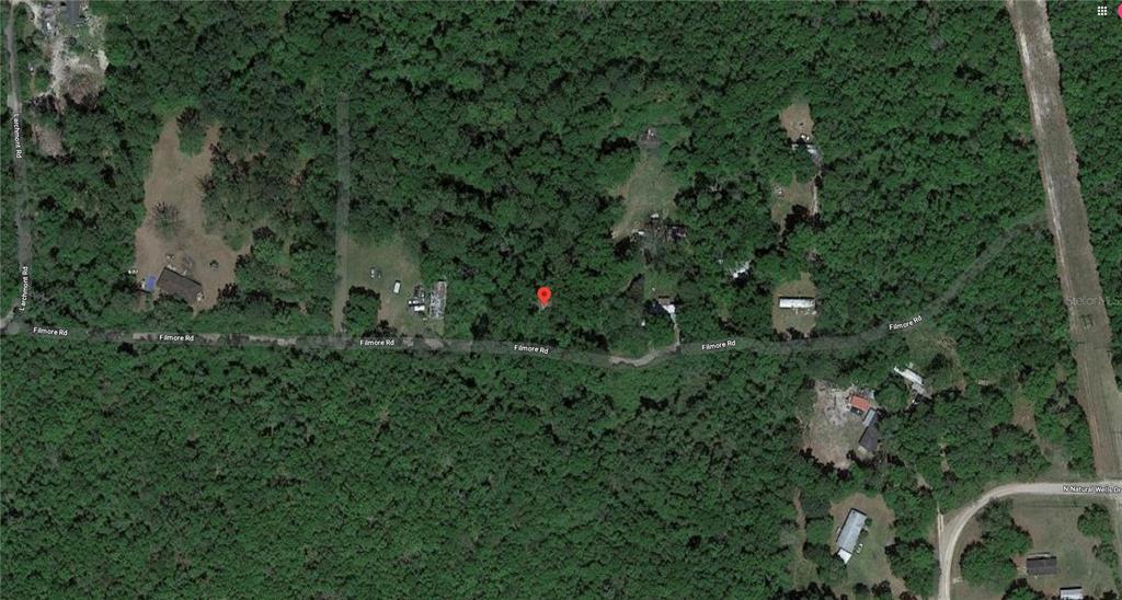 This is an aerial map view showing a wooded lot with a red location marker — 2134 FILMORE ROAD, TALLAHASSEE, FL