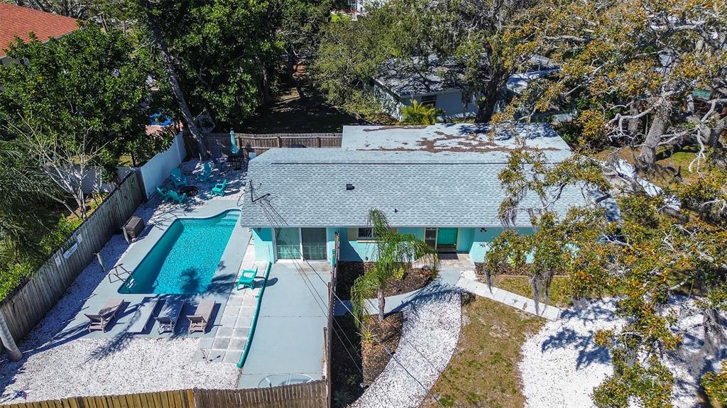 An aerial view shows a single-story house with a swimming pool and a fenced yard — 201 SOUTH STREET, PALM HARBOR, FL