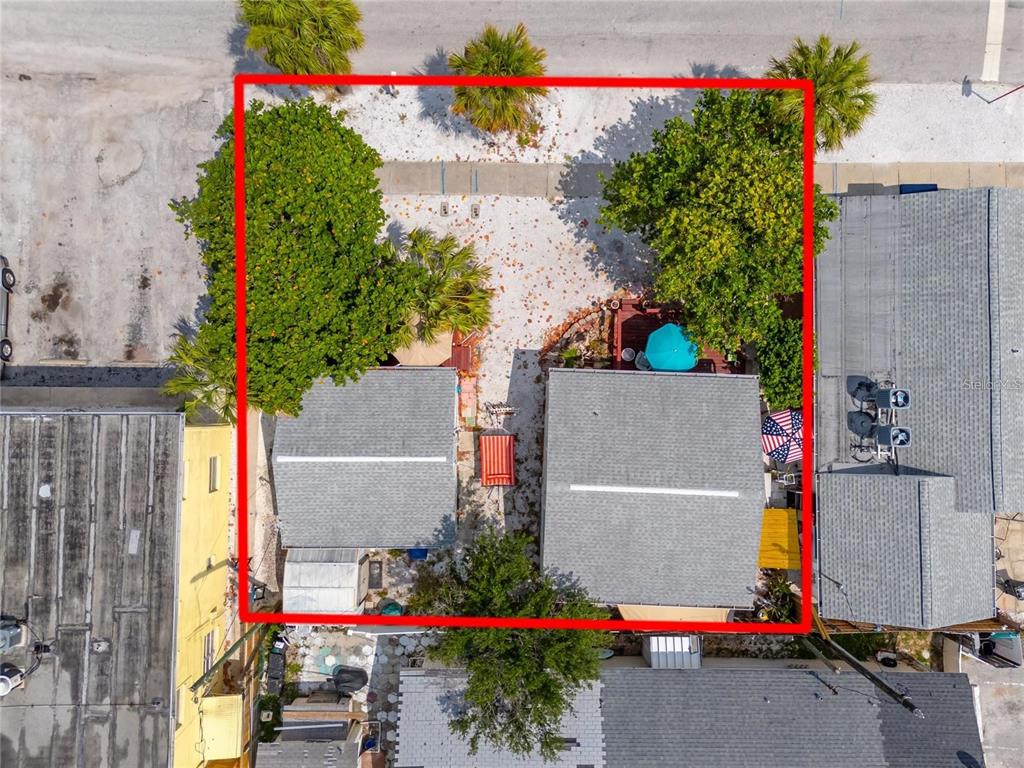 An aerial view shows two small houses on a lot outlined in red — 610 72ND AVENUE, ST PETE BEACH, FL