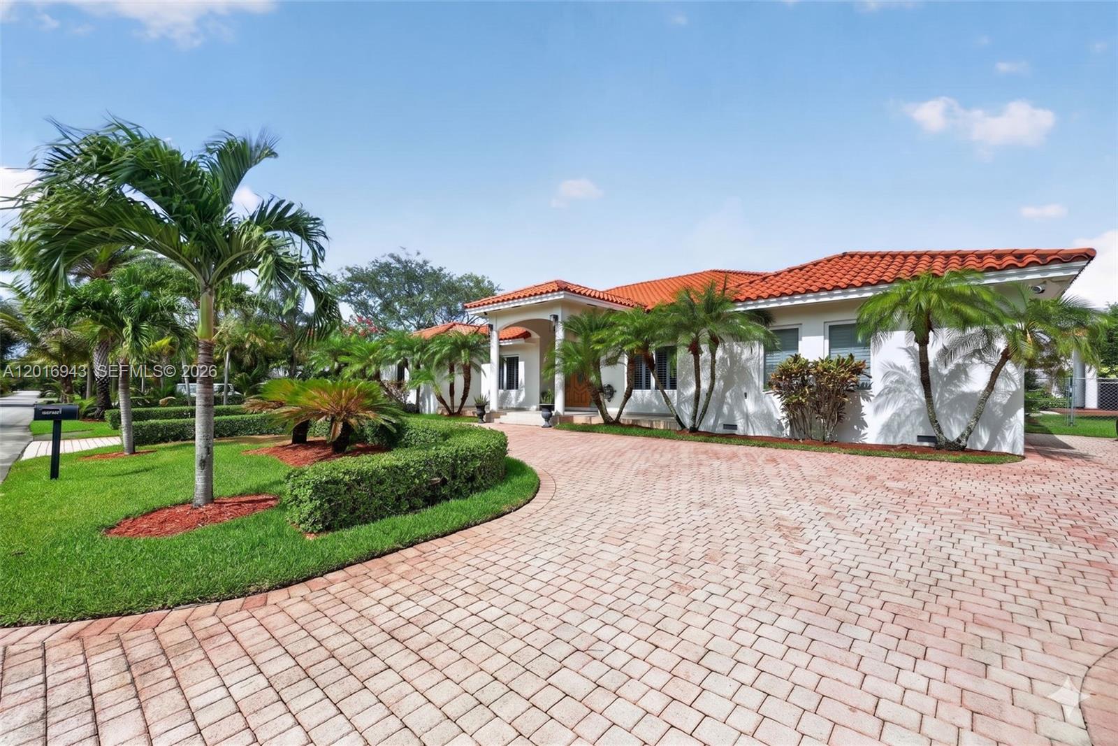A white house with a red tile roof features a circular brick paver driveway — 18461 SW 83rd Ave, Cutler Bay FL 33157, CUTLER BAY, FL