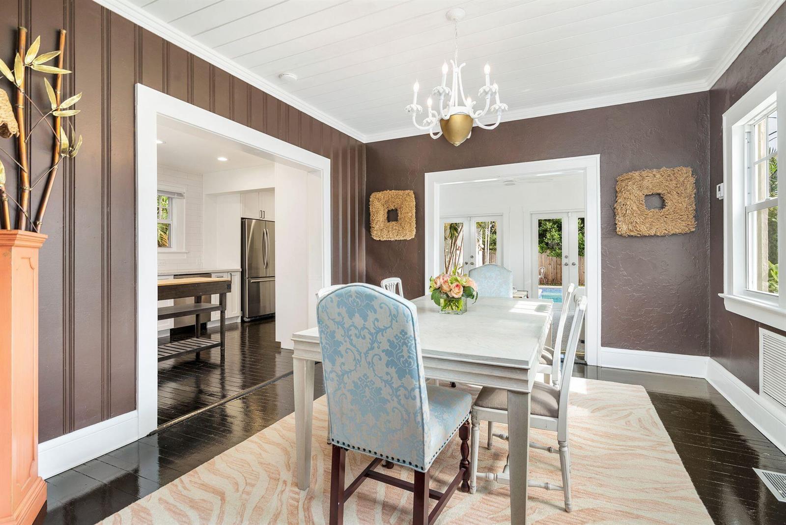 A dining room features dark brown walls, a white plank ceiling, and a light-colored table — 3504 S Olive Avenue, West Palm Beach FL 33405, WEST PALM BEACH, FL
