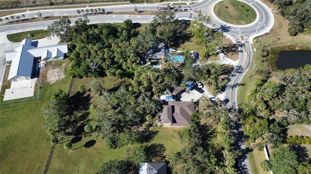 An aerial view shows a residential property with a house, pool, and surrounding wooded grounds — 6500 RICHARDSON ROAD, SARASOTA, FL