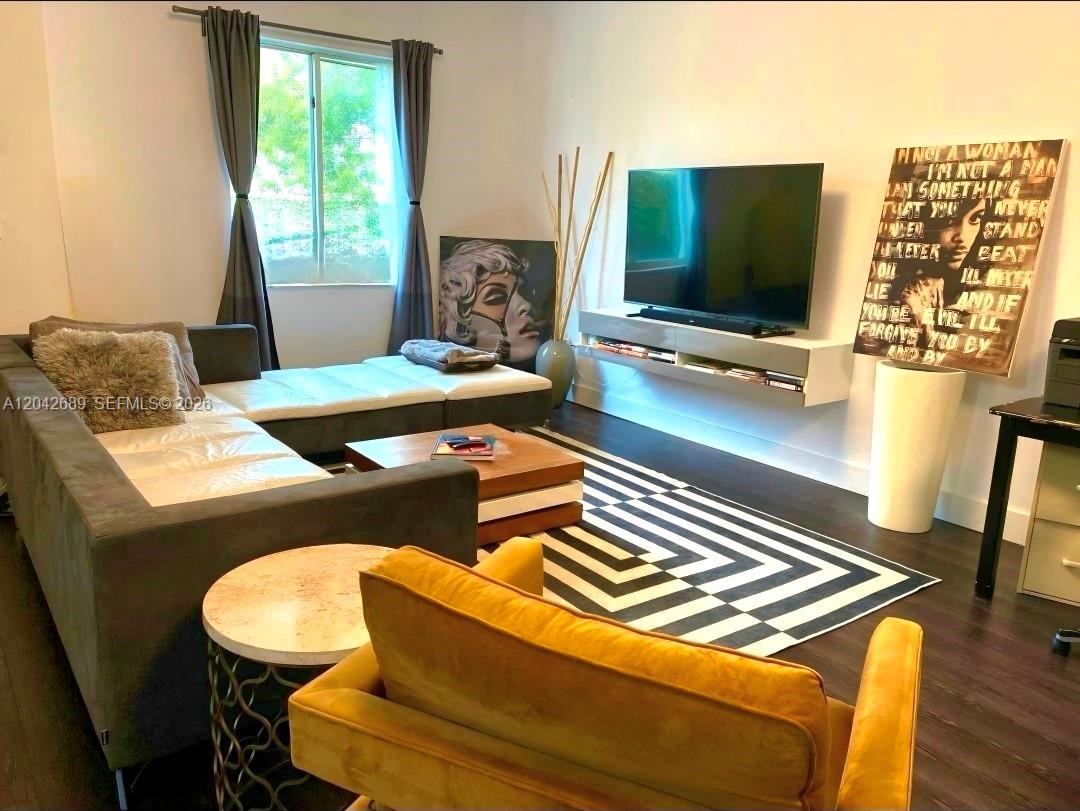 A living room features a grey sectional sofa, a television, and a patterned area rug — 2732 SW 26 St # 2732, Miami FL 33133, MIAMI, FL