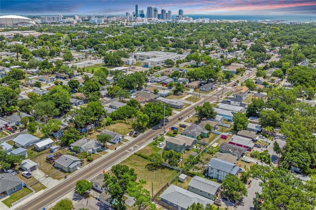 An aerial view shows a residential neighborhood with a road leading toward a city skyline — 15TH AVENUE S, ST PETERSBURG, FL